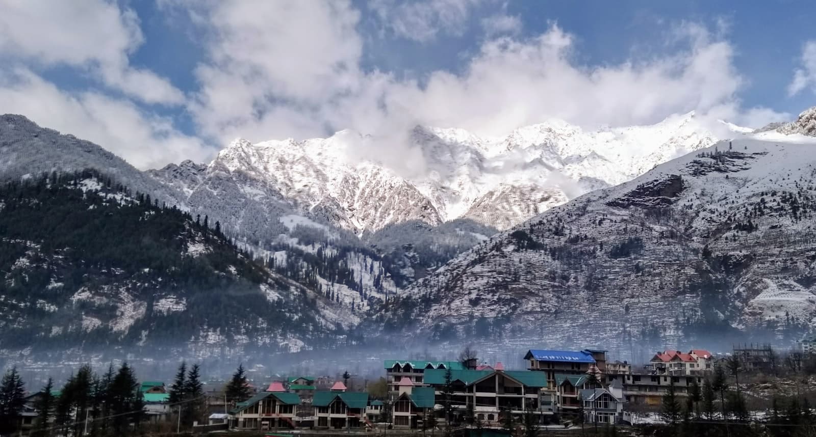 Manali town below snow-covered Himachal mountains