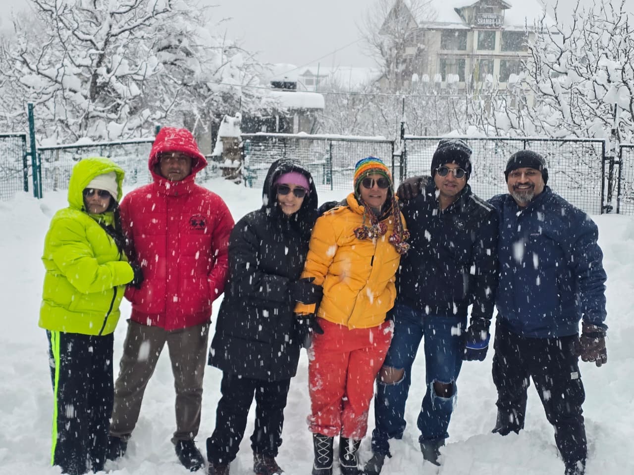 A family group in bright jackets enjoying fresh snow