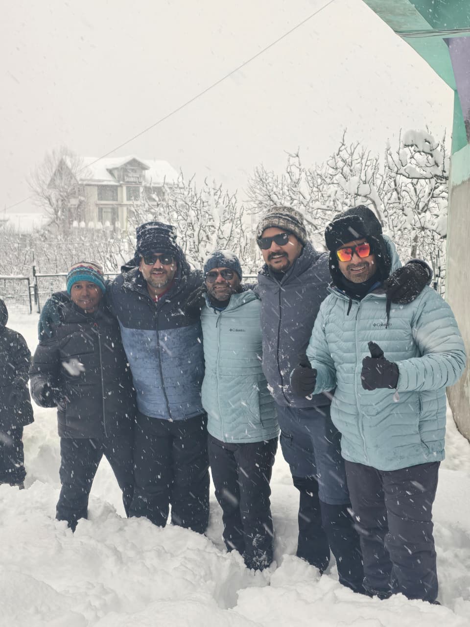 Travellers on a winter trip with us, smiling in fresh snow