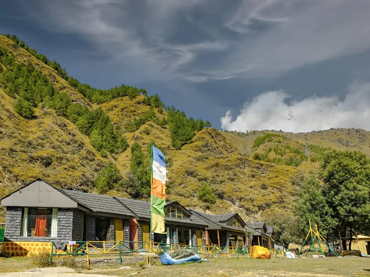 Row of cottages under forested hills in the Pabbar valley