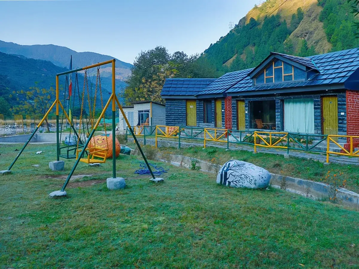 Lawn, swings and cottages at the resort