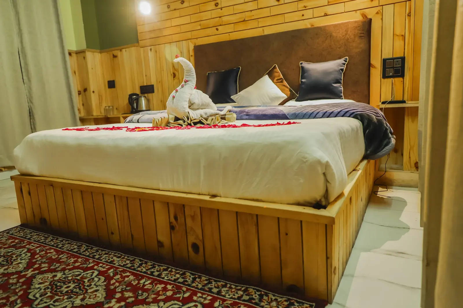 Double bed against pine panelling