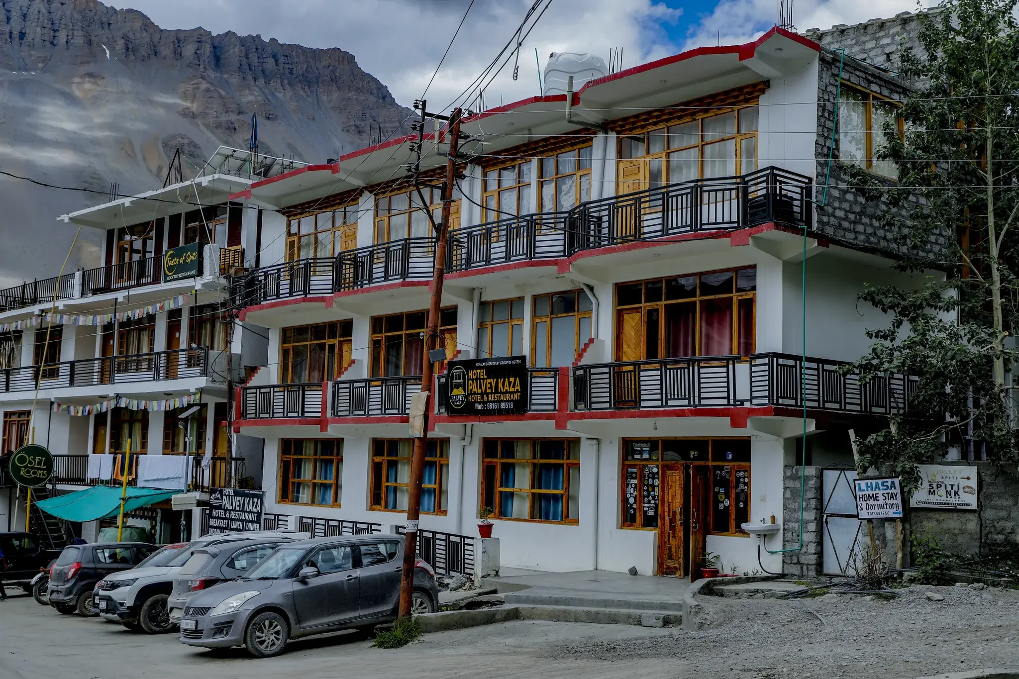 Hotel Palvey's balconied front on a Kaza street below the mountains