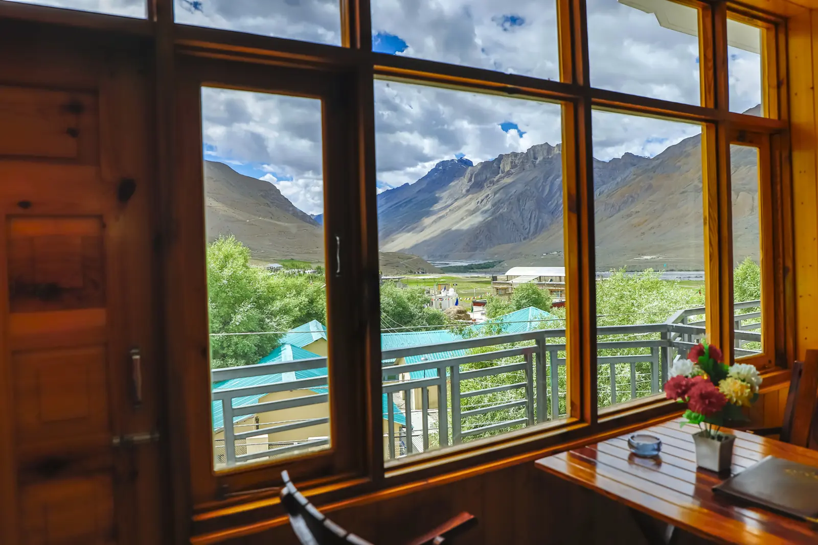 Spiti mountains framed by a room window at Hotel Palvey