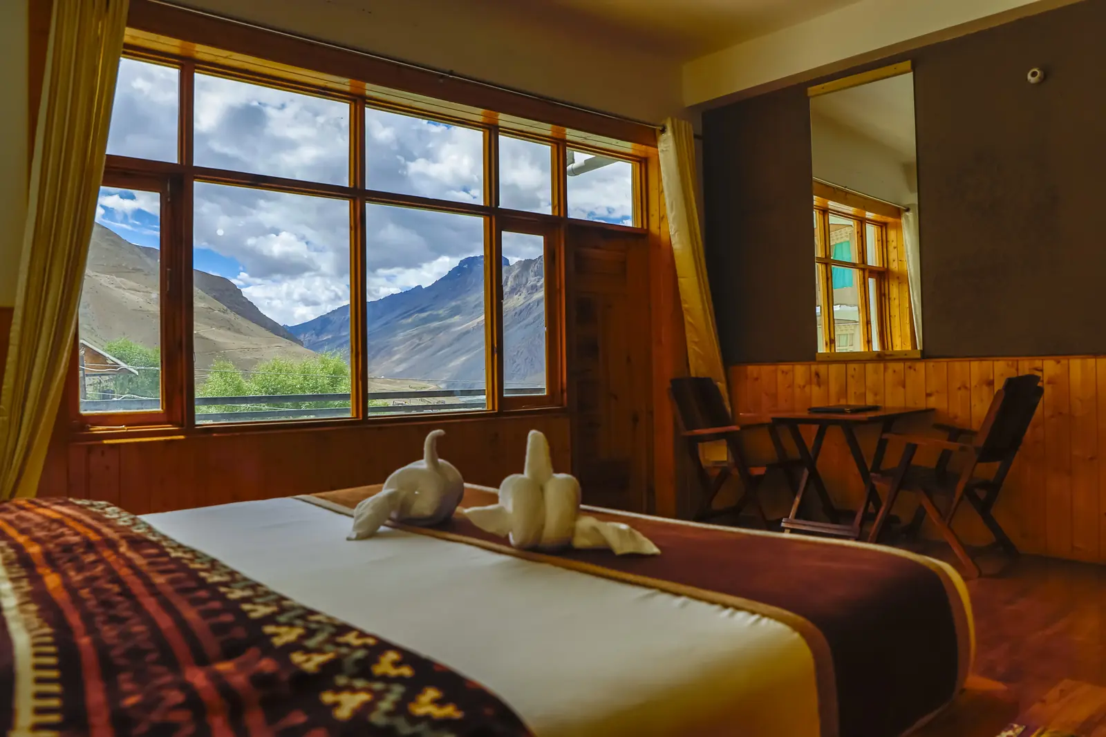 Room with a wide window onto the Spiti range
