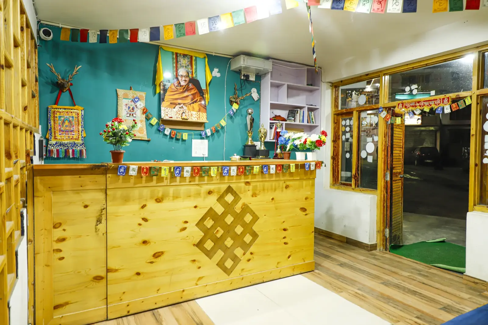 Reception with Tibetan thangkas and an endless-knot carving