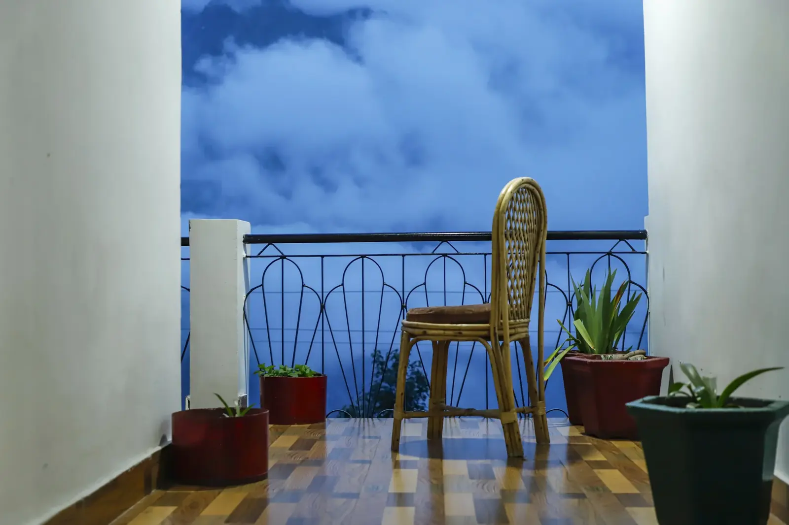 A balcony chair facing the peaks at dawn