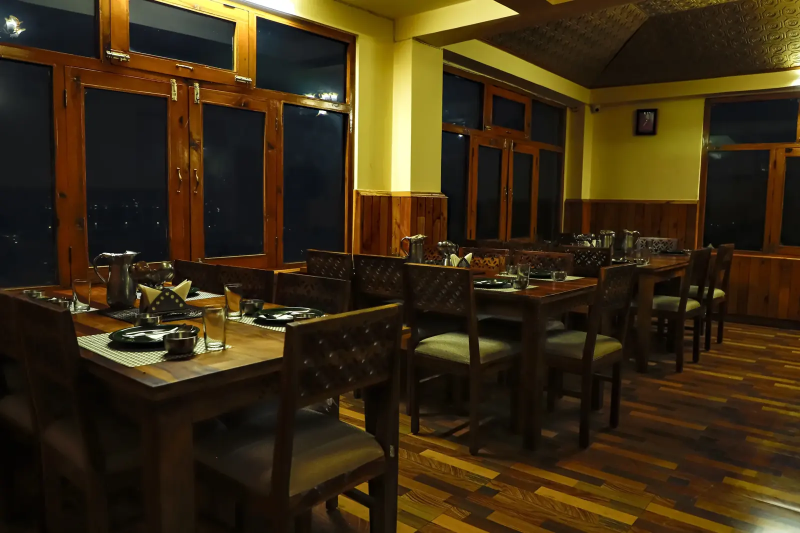 Dining hall with wooden tables and wide windows