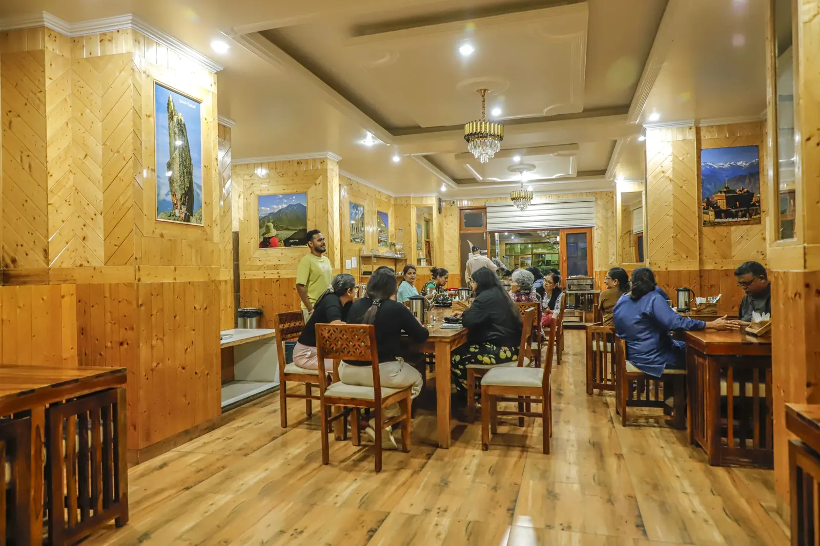 Wood-panelled dining hall with guests at dinner