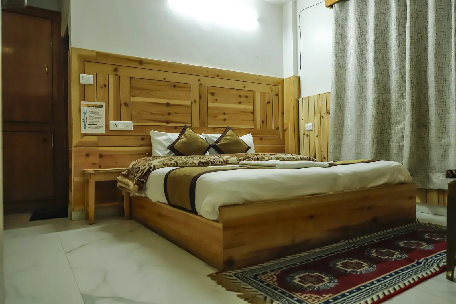 Double room with a Kinnauri rug