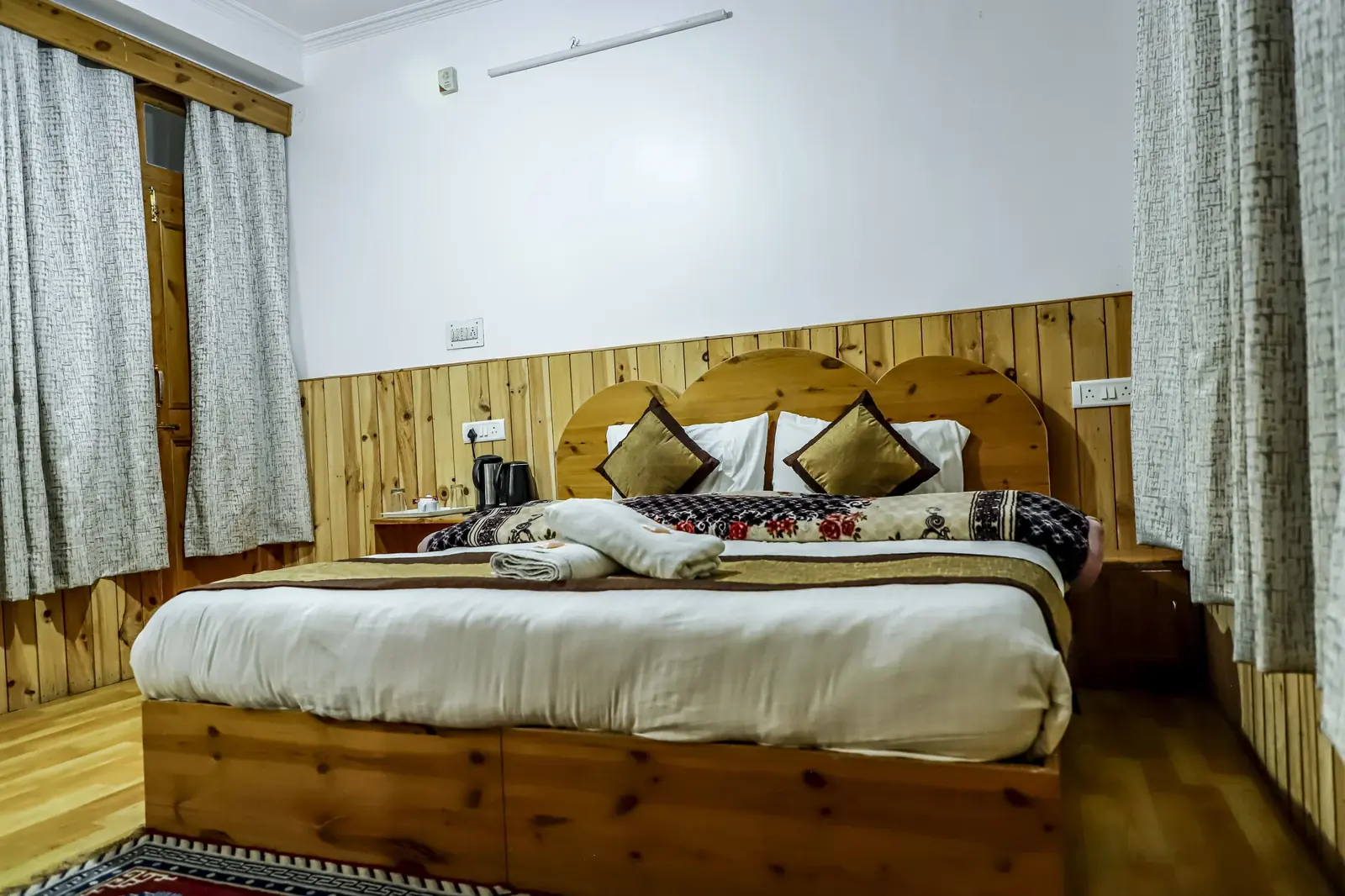 Room with a carved wooden headboard