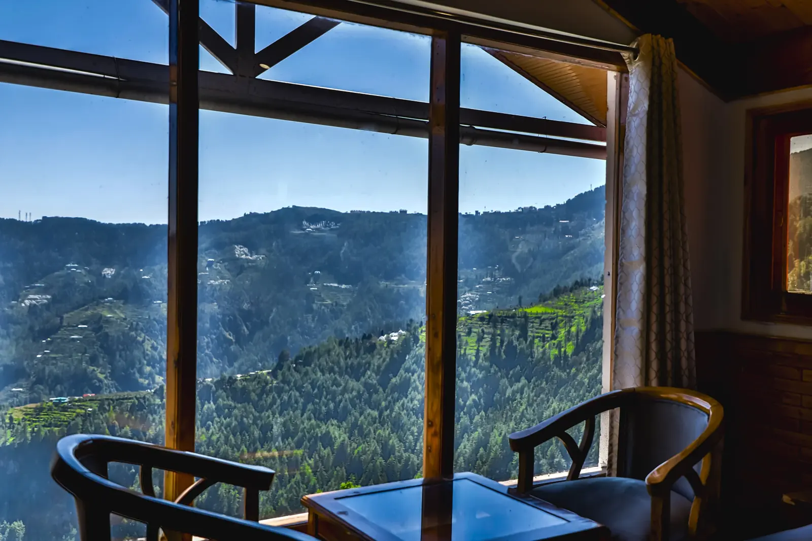 Window seats facing pine-covered ridges