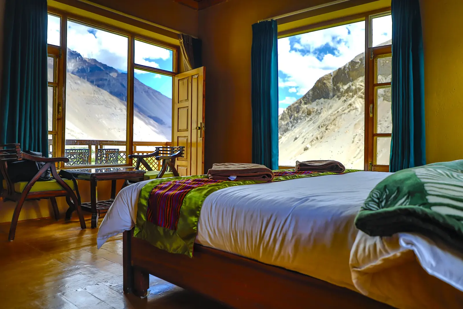 Room with tall windows onto the bare Tabo hillside